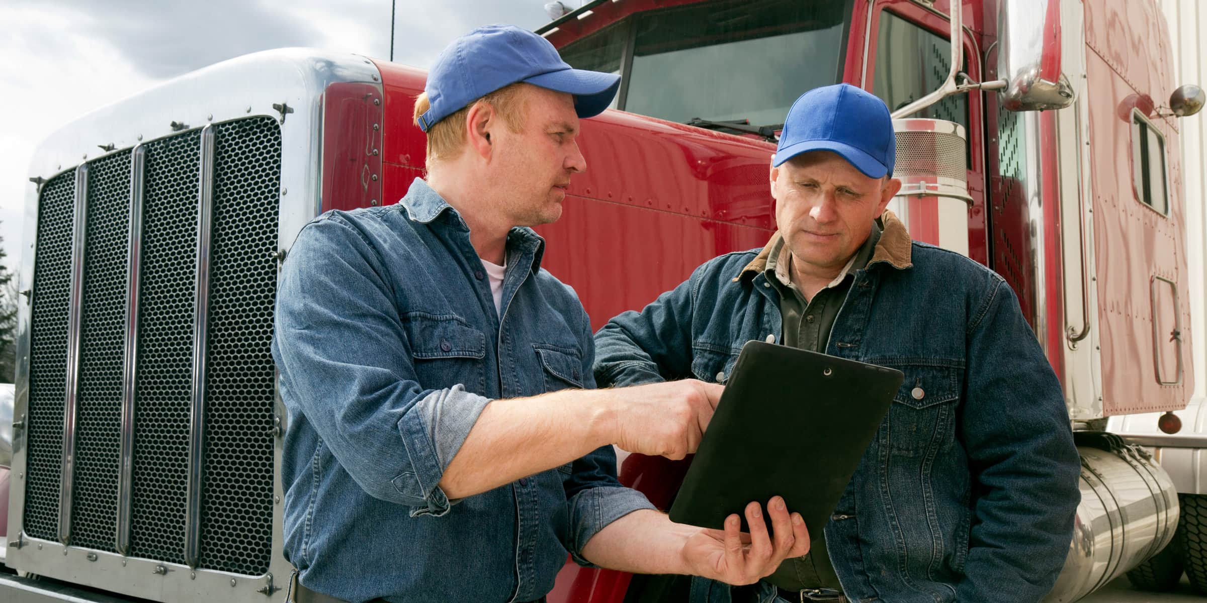 Truck drivers talking with iPad
