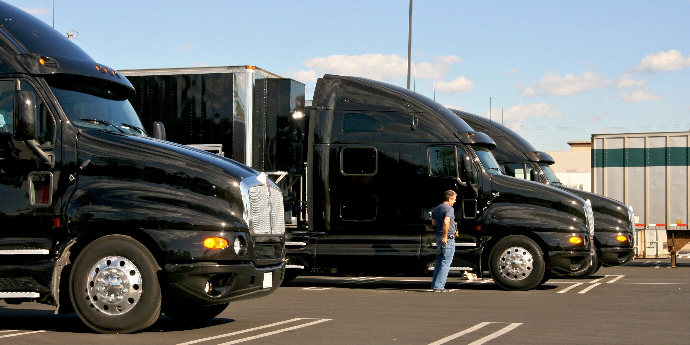 three black semi trucks