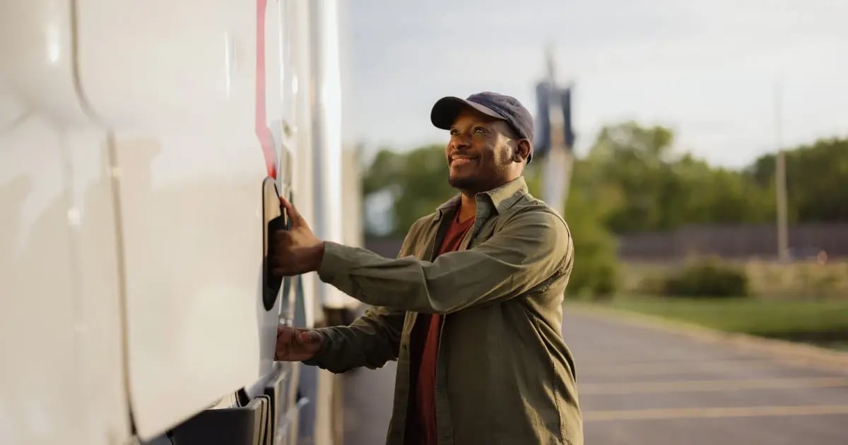 Owner operator grabs the handle of his truck door