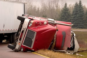 a truck flipped on its side in a ditch