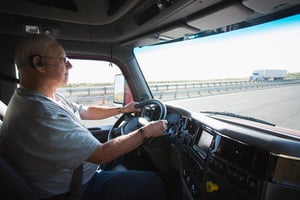 man driving truck on highway